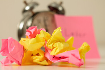 Alarm Clock and Stickers: An alarm clock set against a backdrop of many colorful sticky notes, symbolizing work, fatigue