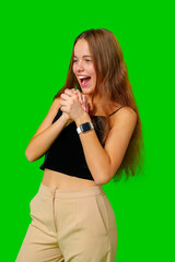 Young Woman Celebrating Success With Raised Fists Against Green Screen Background