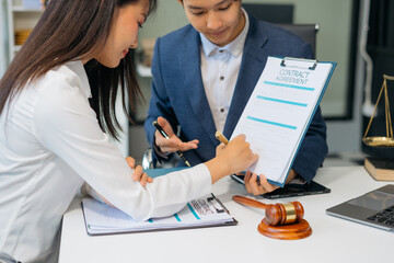 Business people and lawyers discussing contract papers sitting in the table at office, concepts of law, advice, legal services.