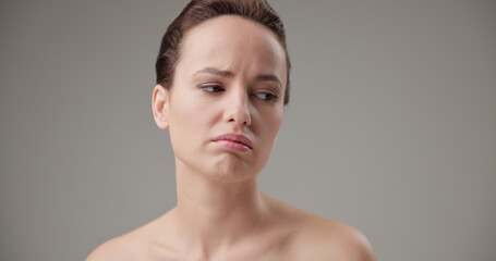 Beauty, health, cosmetics, anti-aging therapy and skin care concept - young beautiful brunette Caucasian woman in a bad mood, upset and disappointed experiencing negative emotions