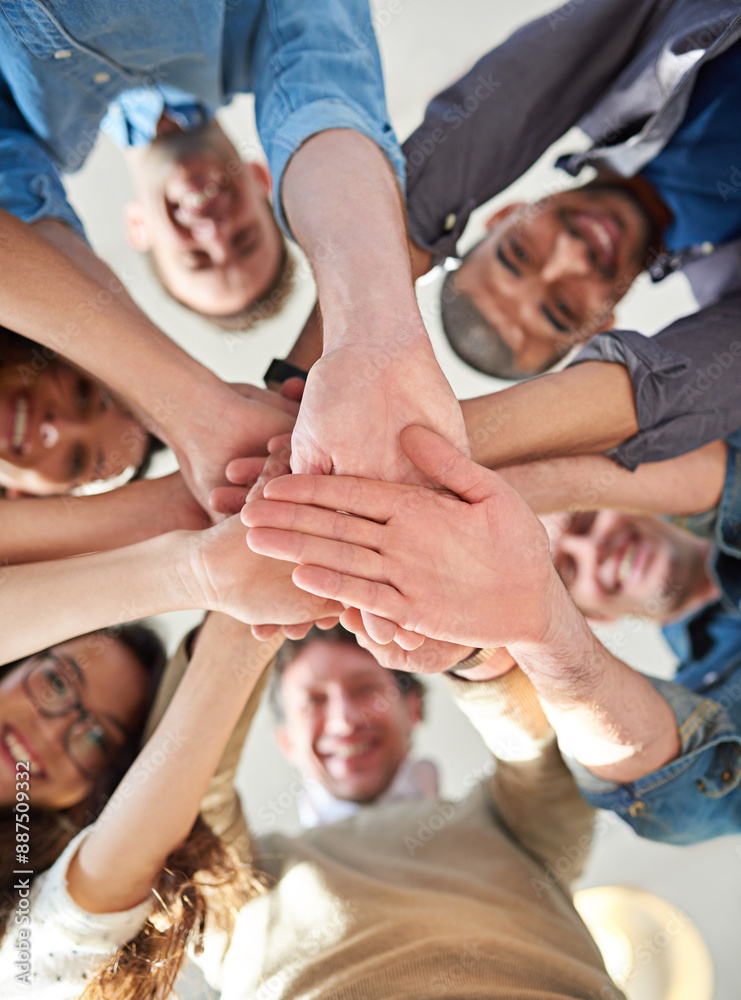 Aufkleber getting it done through teamwork. low angle shot of a group of co-workers stacking their hands on to