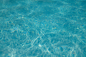 Blue water texture background. Background of pool water surface. Blue aqua water surface. Blue pool water texture background. Surface of swimming pool.