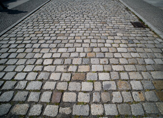 Cobblestone pavement background. Textured background of cobblestone road. Cobblestone pavement for background. Cobblestone road background. Sidewalk.
