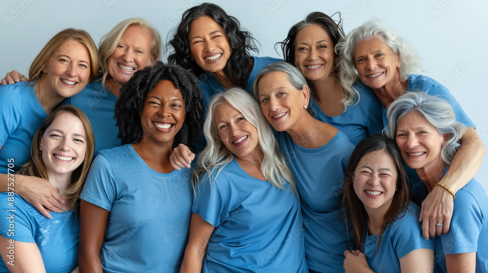 Wall mural A diverse group of women in blue t-shirts, spanning various ages and ethnicities, posing together