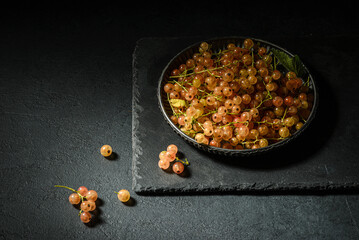 white currant on a black plate