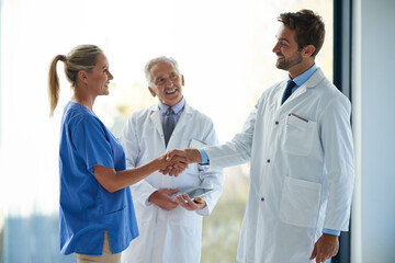 Healthcare, teamwork and medical people with handshake for greeting, introduction and welcome with...