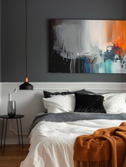 interior of a stylish bedroom with a painting on the wall 