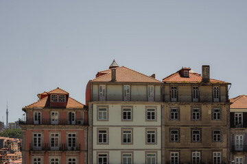 A row of urban buildings standing against a clear blue sky