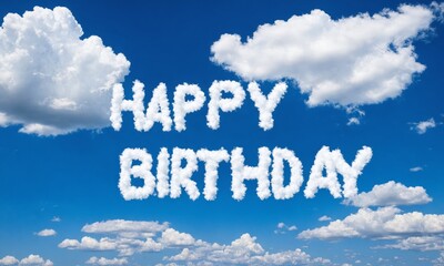 Happy birthday message written in clouds against a blue sky