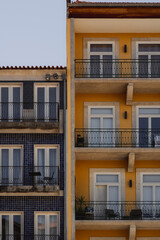 Several structures in yellow and blue with balconies