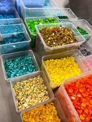 Photo of an ecological center: sorting plastic bottle caps by color. Environment care concept. Phone photo, not AI