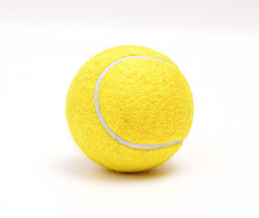A Close-Up Photo Of A New, Vibrant Yellow, Textured Tennis Ball Showcasing Under Bright Lighting