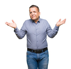 Middle age arab business man over isolated background clueless and confused expression with arms...
