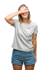 Young beautiful woman over isolated background smiling and laughing with hand on face covering eyes for surprise. Blind concept.