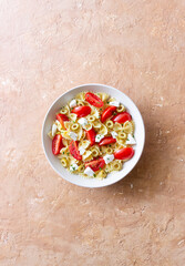 Farfalle pasta with white cheese, tomatoes and olives. Healthy eating. Vegetarian food.