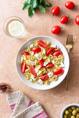 Farfalle pasta with white cheese, tomatoes and olives. Healthy eating. Vegetarian food.