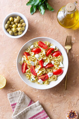 Farfalle pasta with white cheese, tomatoes and olives. Healthy eating. Vegetarian food.