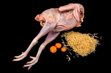 Raw hen body, 3 yolk, noodle on black background.