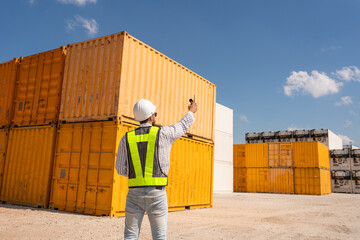 Container yard worker checking container at container yard warehouse.