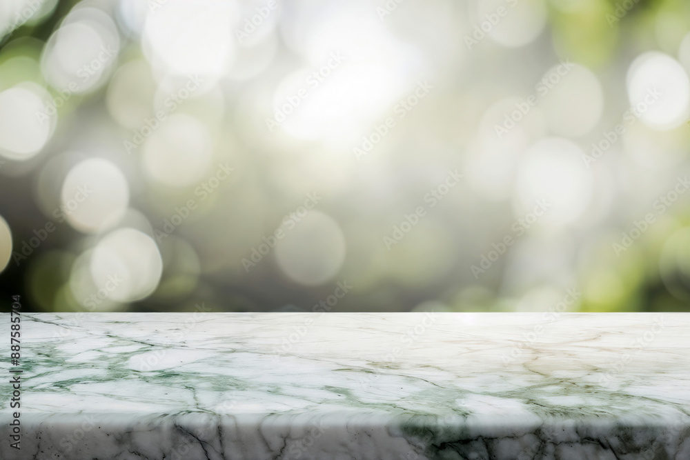 Fototapete empty marble table top against a soft green bokeh background, perfect for product display