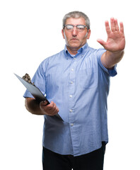 Handsome senior inspector man holding clipboard over isolated background with open hand doing stop sign with serious and confident expression, defense gesture