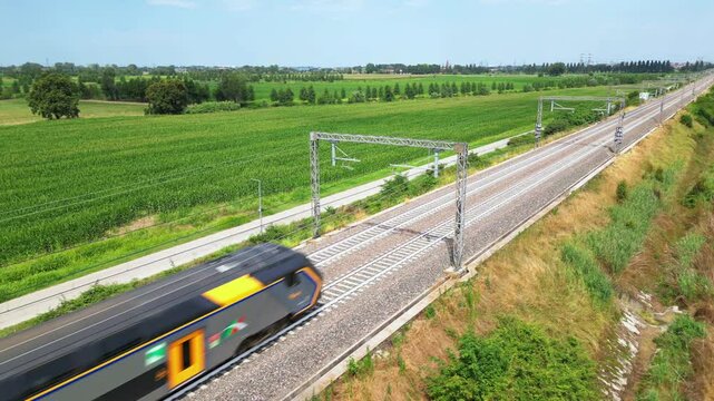 Europe, Italy , Milan - Frecciarossa Hight speed 300km h train raylway from Milano  to Rome view from the drone - the faster way to travel in Italy for tourist and passengers - tourist destination 