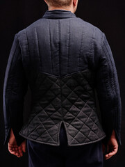 Historical fashion. Medieval knight cloth. Padded jacket gambeson.