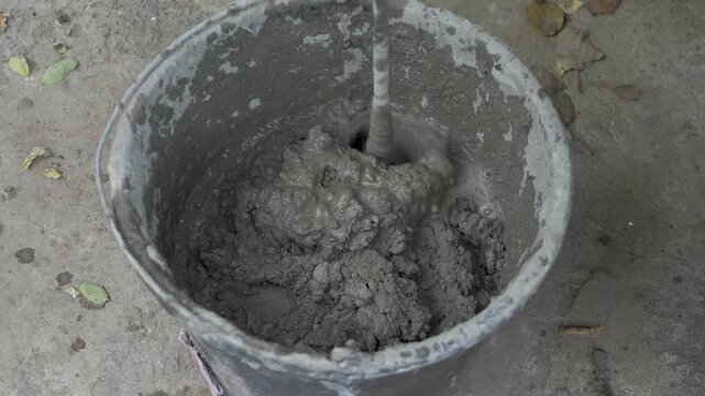 When you need to tile a wall, first prepare the bonding compound. Use an electric mixer to ensure the mixture is even and smooth. This helps in making sure the tiles stick firmly to the wall