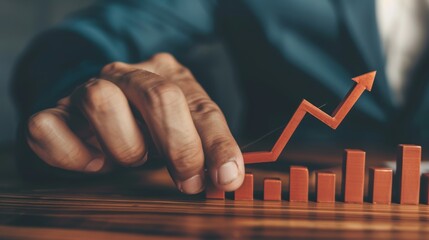 A businessman pointing to an arrow graph symbolizing corporate future growth plans