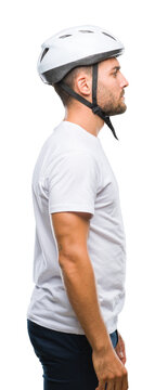 Young handsome man wearing cyclist safety helmet over isolated background looking to side, relax profile pose with natural face with confident smile.