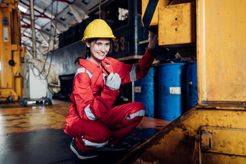 Portrait of woman engineer standing and looking camera in train factory. Maintenance cycle concept.