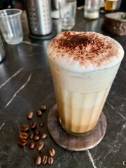 cappuccino with coffee beans on a black background