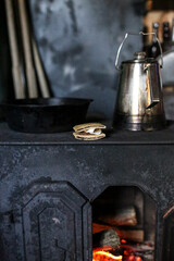 S'mores and a metal kettle on a wood stove,