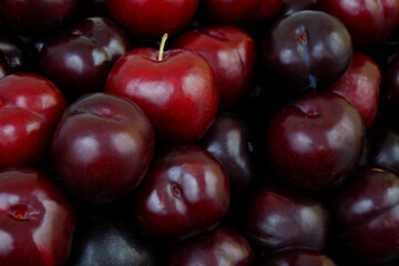 Many ripe plums as background