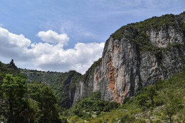 Landscape of cliffs and mountains with cloudy sky in Oaxaca, Mexico.
