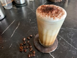 cappuccino with coffee beans on a black background