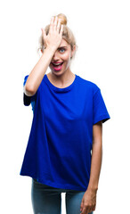 Young beautiful blonde and blue eyes woman wearing blue t-shirt over isolated background surprised...