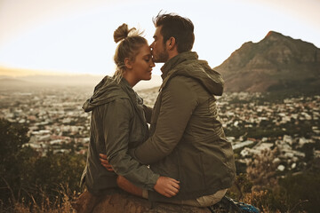 Couple, forehead kiss and mountain for travel in outdoor, cityscape and together on vacation. People, nature and support for freedom on holiday, affection and adventure on cliff for love in marriage