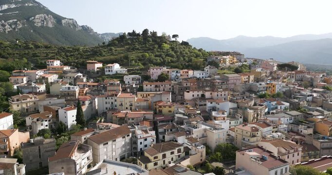 Italian Homes Sitting On A Mountain At Dorgali In Sardinia, Italy. Tracking Aerial Shot.