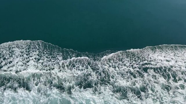 Ocean waves as ship passes with beautiful blue water