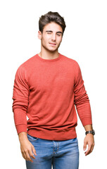 Fototapeta premium Young handsome man over isolated background winking looking at the camera with sexy expression, cheerful and happy face.