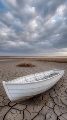 White wooden abandoned boat on dry parched land. Water dried up. Climate change, global warming.