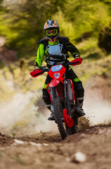 Professional enduro bike rider on action, dirt ride on the dusty track Motocross sport. © Malik Nalik