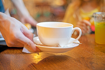 taking hot tea in a white cup in the school canteen. snack. back to school