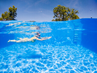 woman swimming in clear blue pool