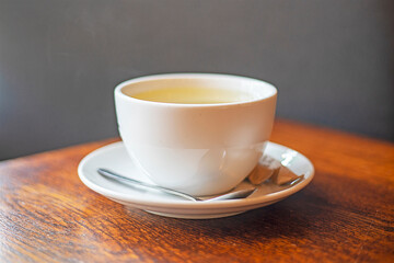 hot drink tea or coffee in a white cup on a bluetz, good morning