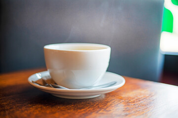 hot drink tea or coffee in a white cup on a bluetz, good morning
