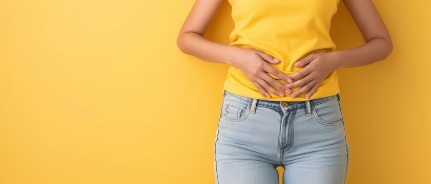 A person holding their stomach and smiling, indicating a healthy and happy gut