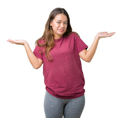 Young beautiful brunette woman over isolated background clueless and confused expression with arms...