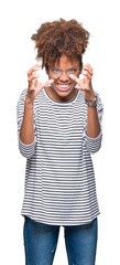 Beautiful young african american woman wearing glasses over isolated background Shouting frustrated with rage, hands trying to strangle, yelling mad